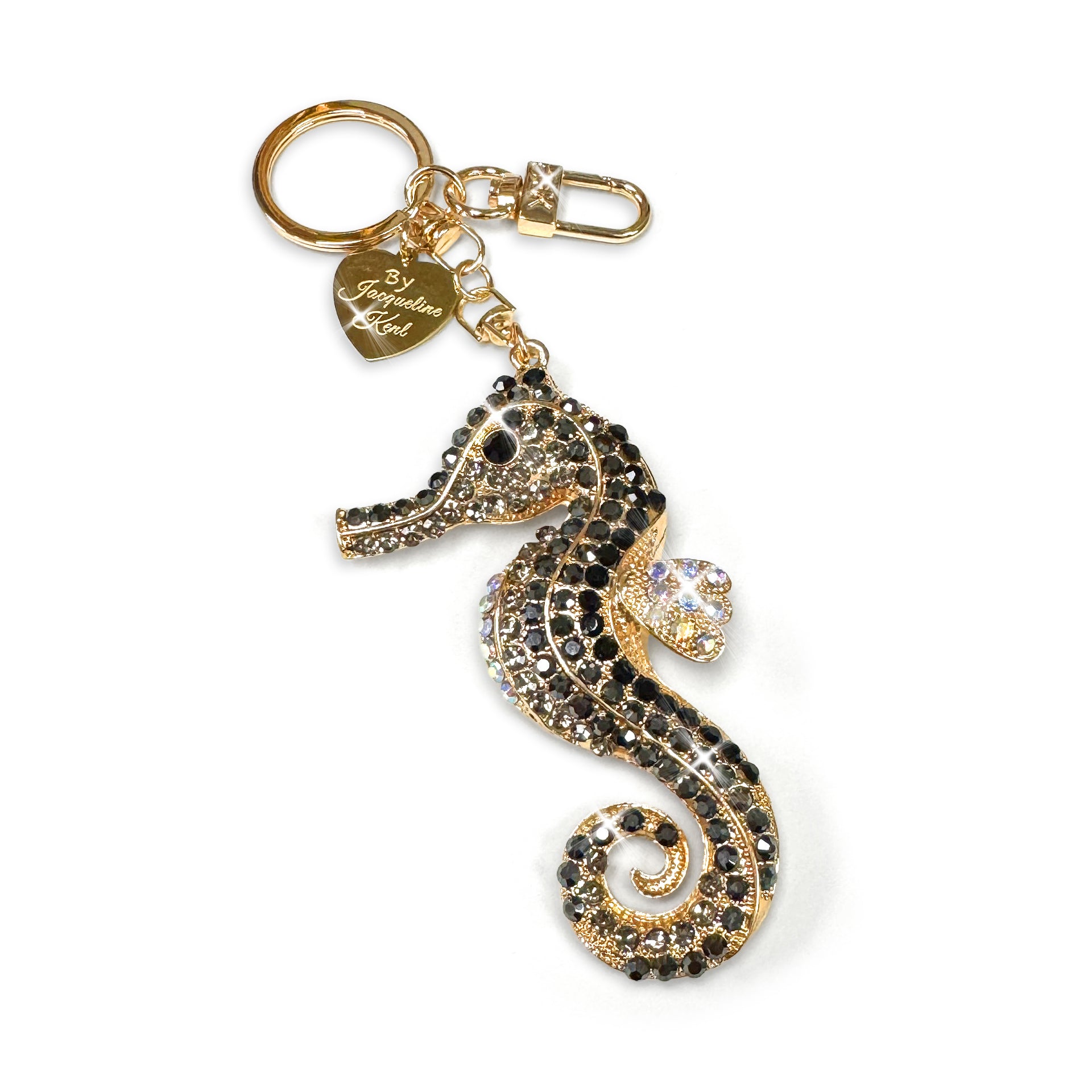 Gold and black and Ab crystal seahorse keychain with a heart-shaped tag on a white background